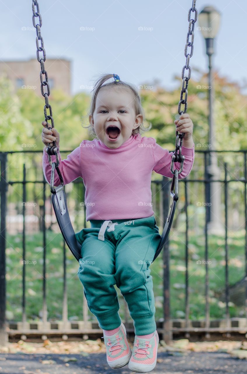 Girl playing on swing