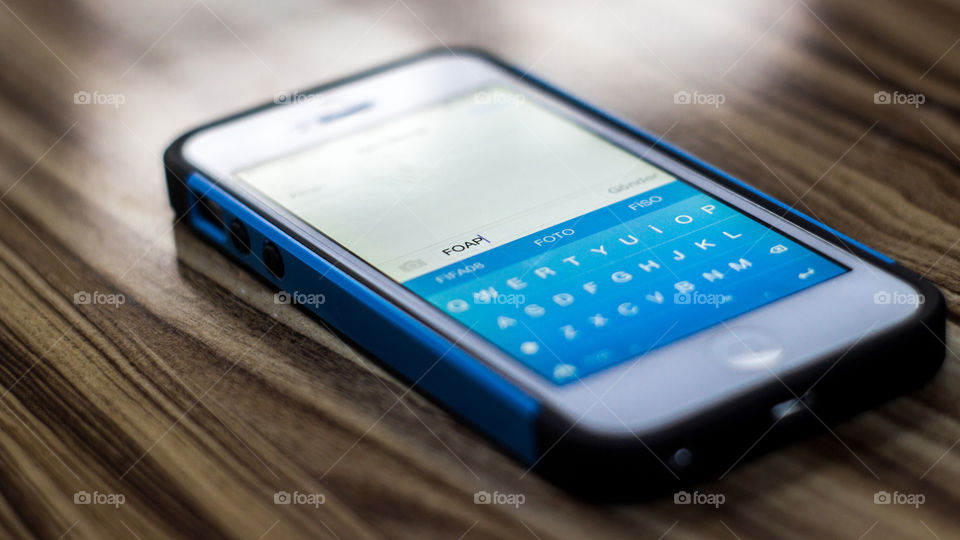 Cellphone on wooden desk