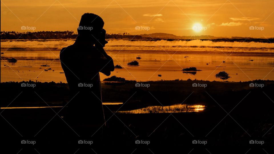 Photographing sunset at beach