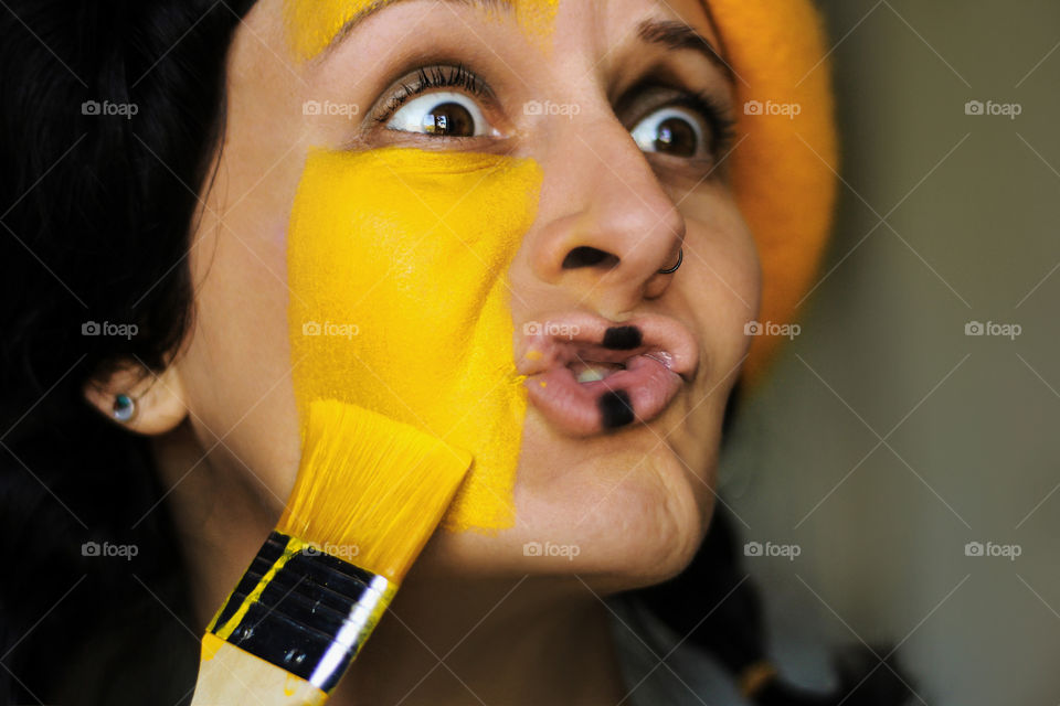 Painting face in yellow color