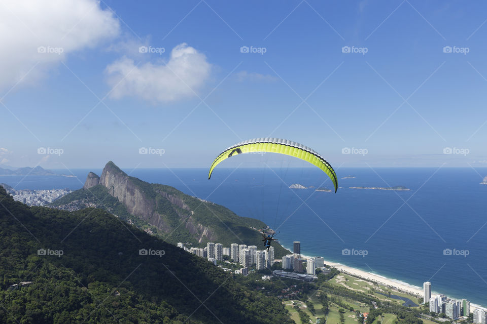 Paraglider flying over Sao Conrrado in Rio de Janeiro Brazil.