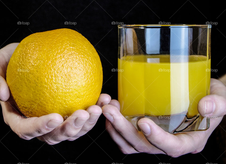 Juice and fruit in the hands of a girl