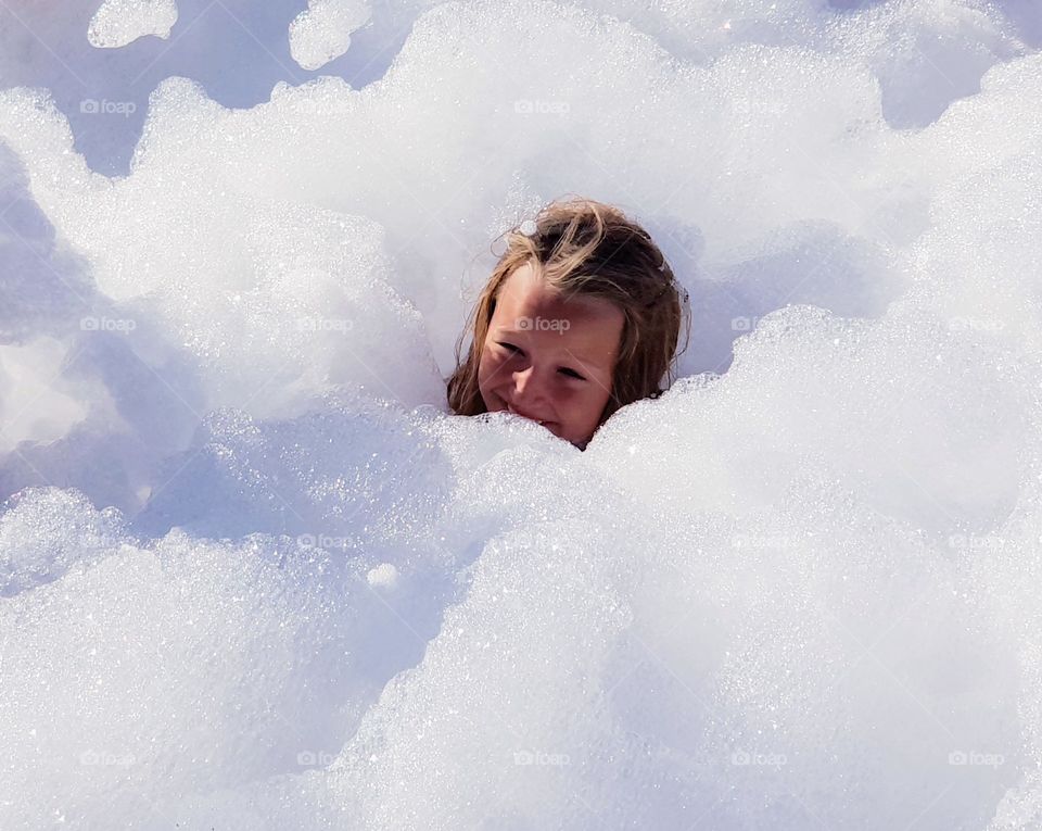 girls head sticking up from foam