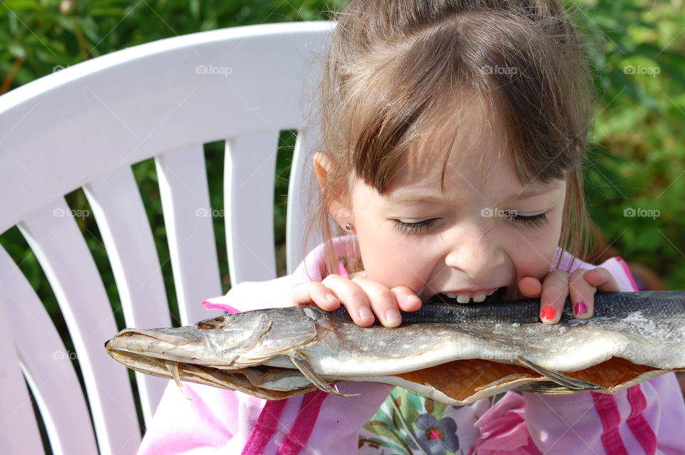Close-up of a girl eating raw fish