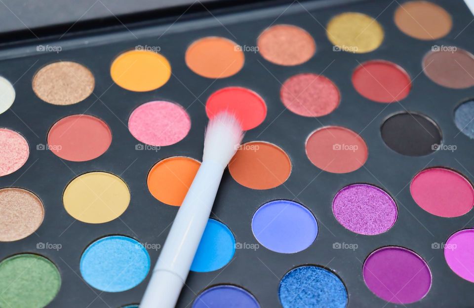 Makeup palette closeup with brush