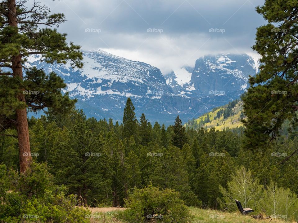 Tall mountains loom over a valley below