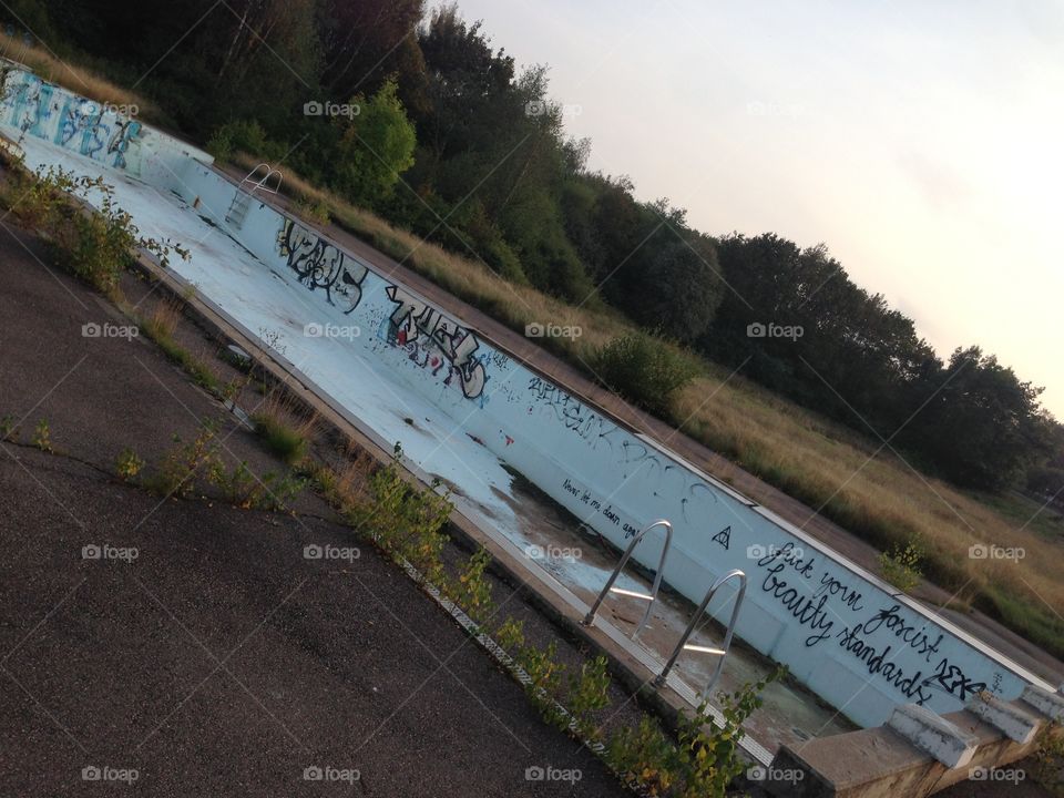 Swimming pool. Old swimming pool covered in graffiti 