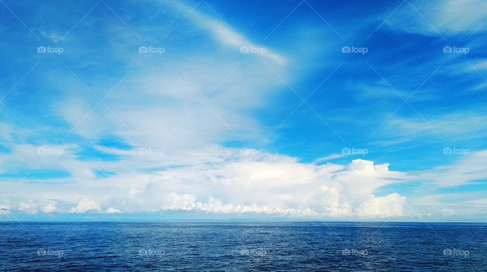 Cloudscape on the sea, abstract "crocodile and rabbit" by cumulusnimbus and cirrostratus clouds.