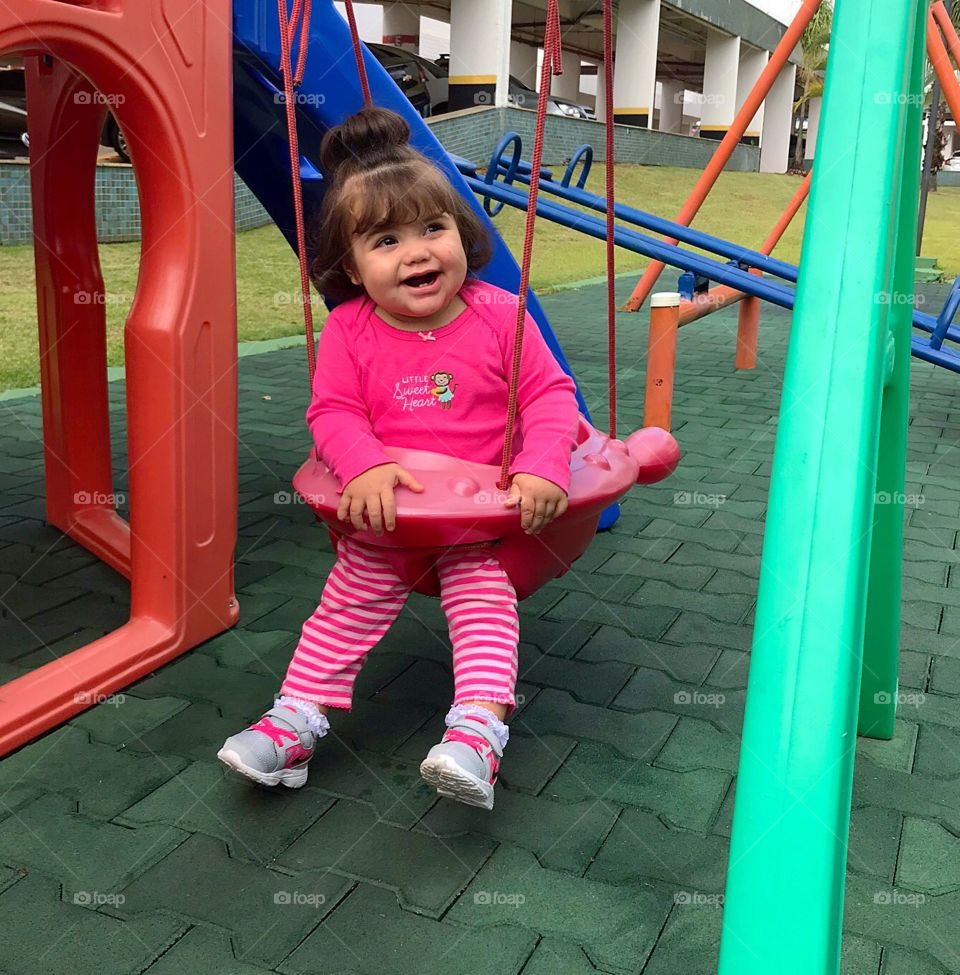 Baby playing on the swing 