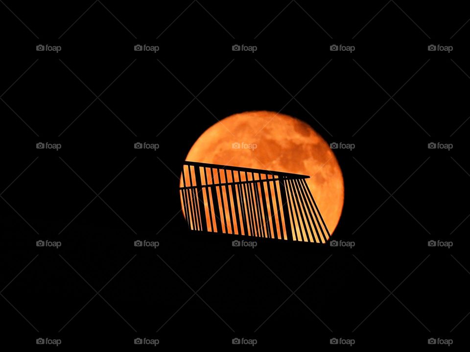 Photo of the month (June) - Fascinating moon shot - The full Strawberry Moon of June 2024 shines over buildings railing at Miramar, Florida and the Gulf of Mexico despite a cloudy sky. I was able to focus in and capture the moons craters