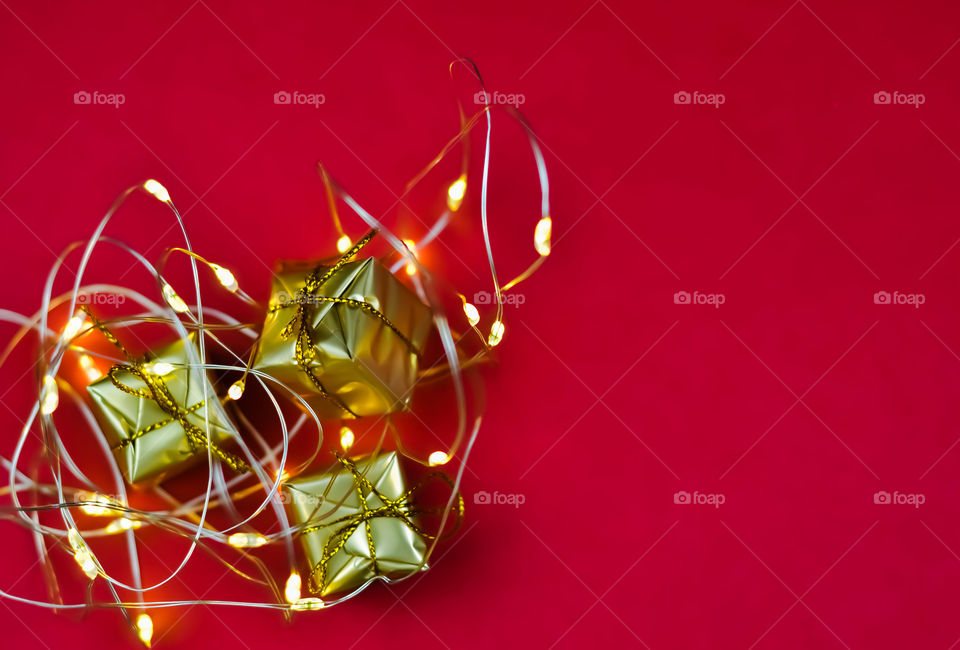 Christmas gifts. Decorations with golden lights.