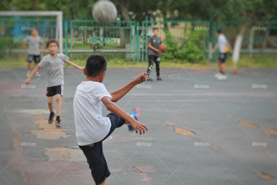 children in the old stadium playing football