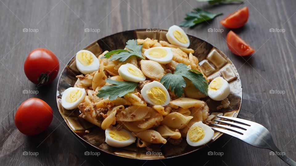 Close-up of pasta and boiled eggs in plate