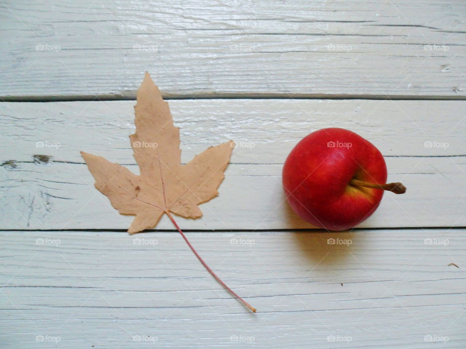 Apple and autumn leaf