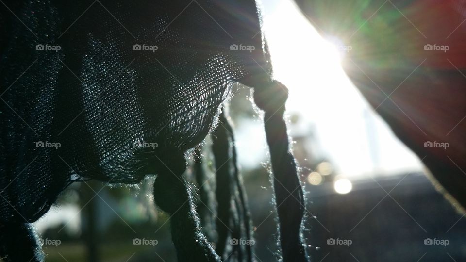 light shining through a window, hanging scarf, artsy