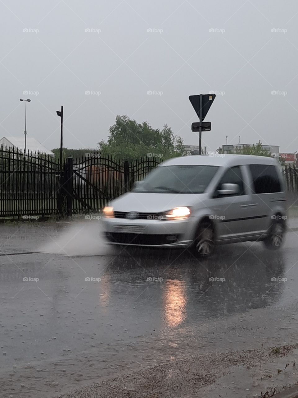 torrential rain - car splahing water on street