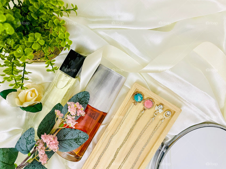 Your best flat lays . Perfumes and accessories and mirror on a white background 