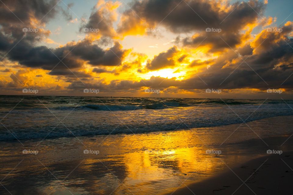 Yellow sunset over cloudy ocean