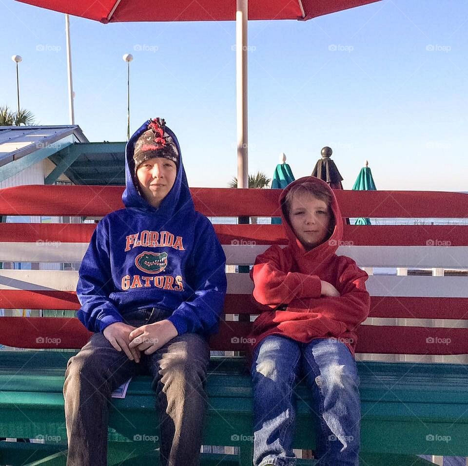 Two brother sitting on bench