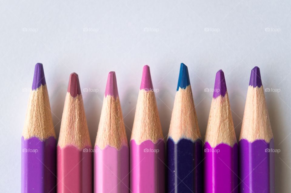 Sharpned purple pencils against white background