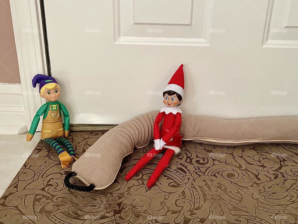 Elf on the shelf antics, elves put up draft protection, elves help to protect our house, cute elf antics 