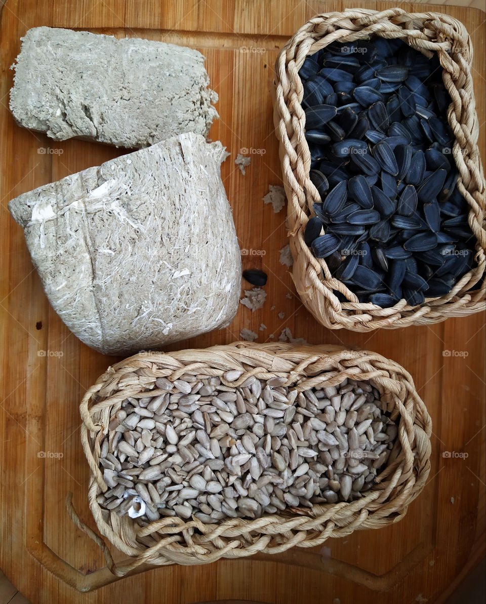 Halva, wicker basket with black sunflower seeds and wicker basket with peeled sunflower seeds