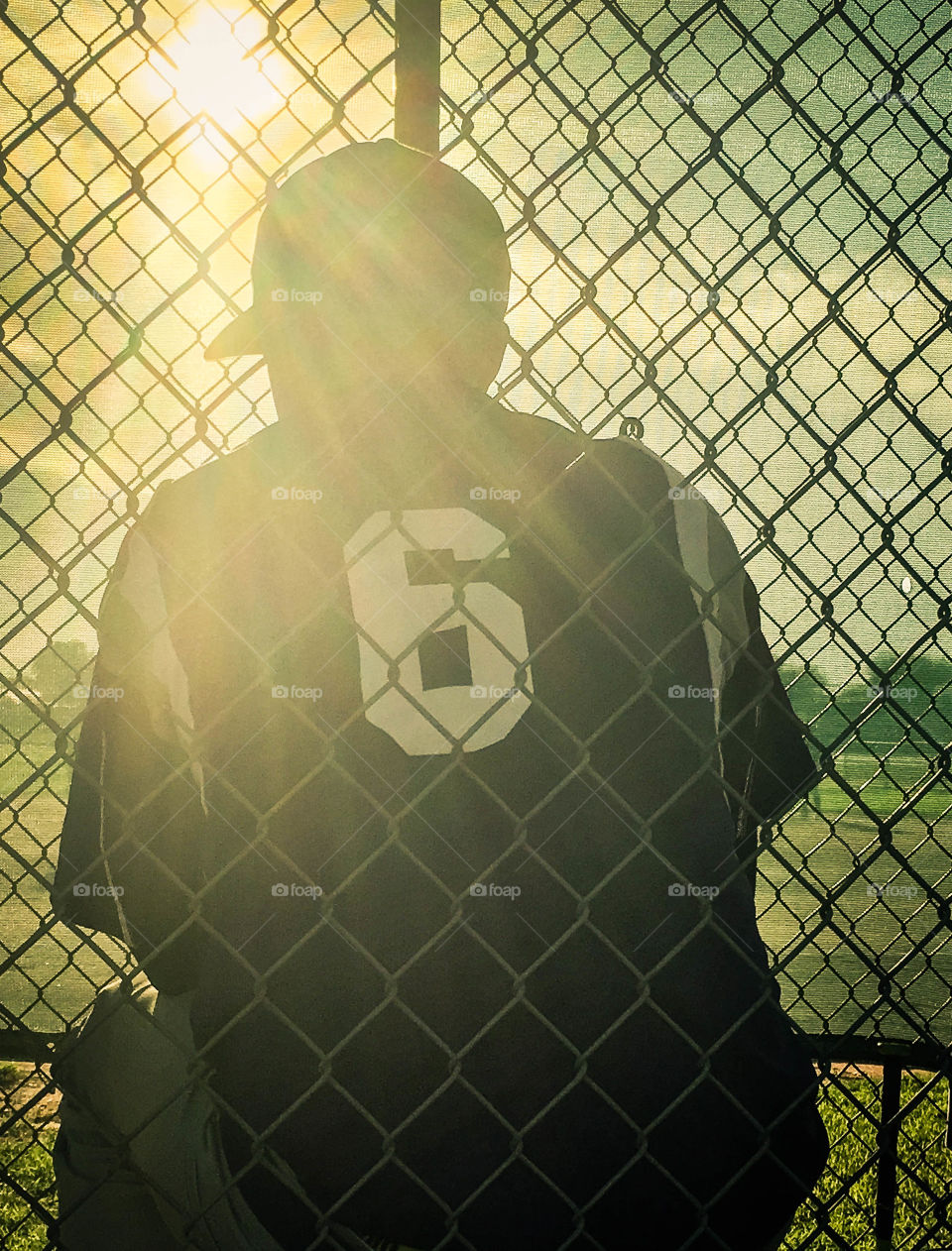 A youth baseball player (pitcher) reflecting before the big game
