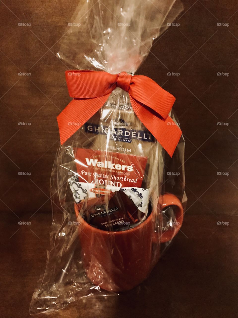 A beautifully wrap Christmas gift of Ghirardelli chocolates and sweet treats a Christmas coffee mug filled with chocolates and coffee packages for a lovely Christmas and holiday gift. USA , America 