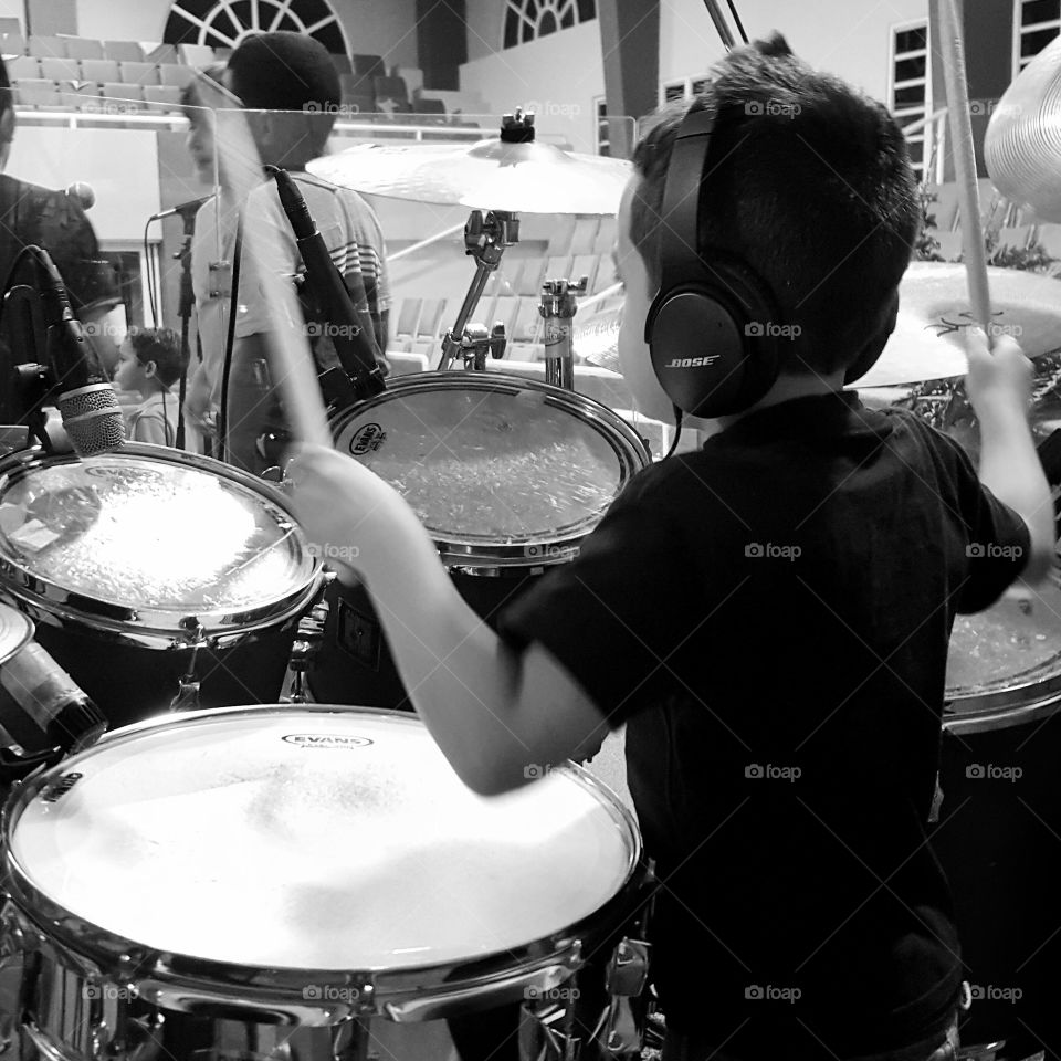 little boy playins drums