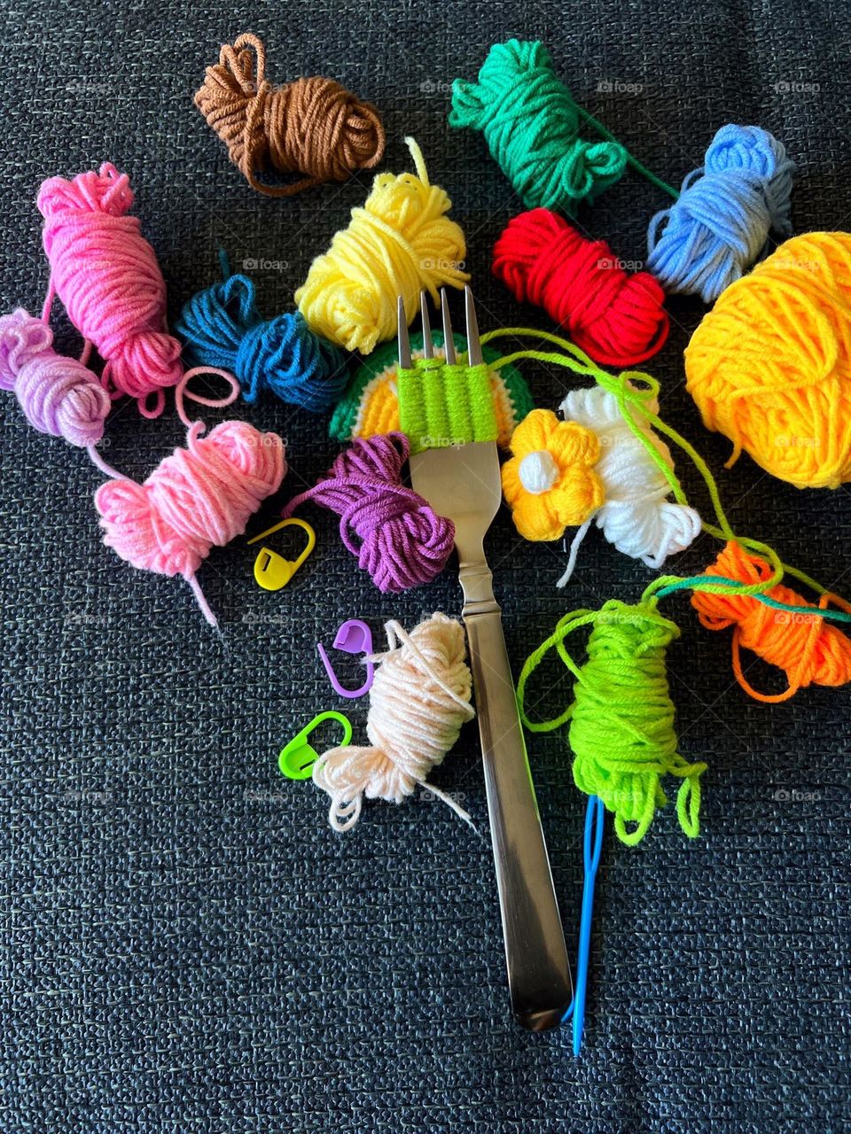 A fork with colorful woolen yarn 