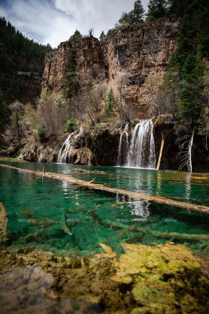 Beautiful crystal clear water flowing from a waterfall into a Colorado lake high in the mountains. 