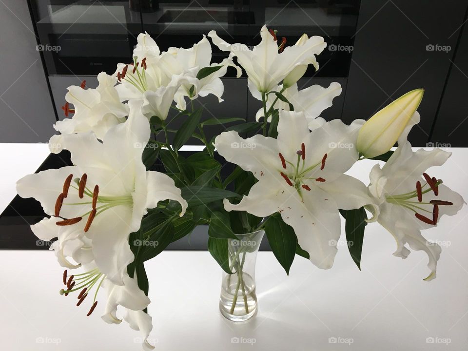 White lilies in a clear glass vase 