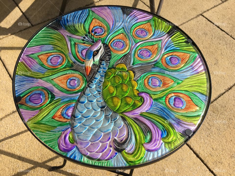 A very colourful round metal garden table ...