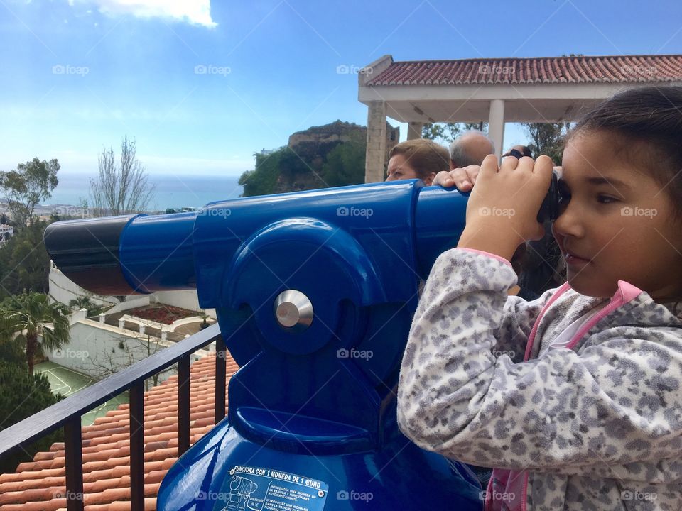 Girl looking through binocular