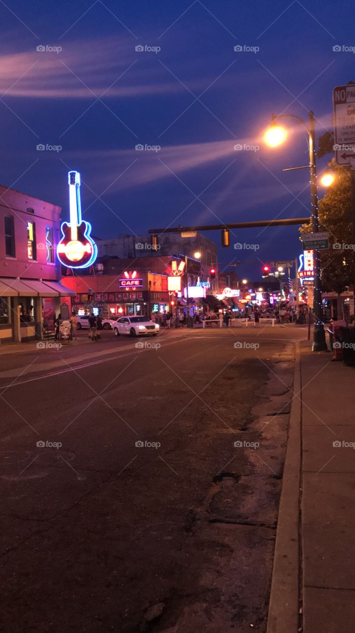 This photo was taken on the 17th of August 2018, it was in Memphis for Elvis week. This is where many people from different age groups and cultures come together to celebrate the life of the King. This photo captures the nightlife and neon lights of 