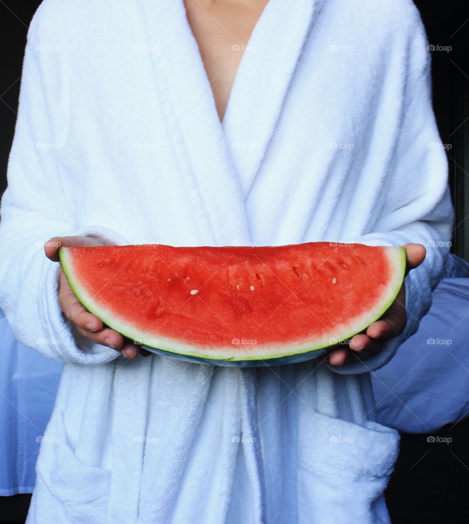 Woman hand holding watermelon slice