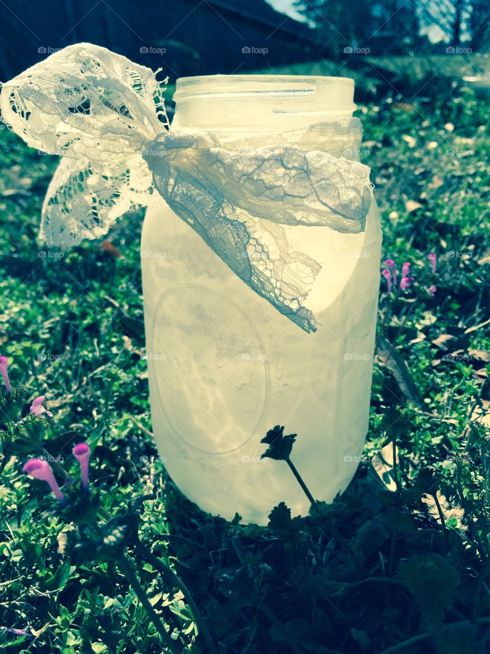 Mason jar with lace . Mason jar outside with a pace ribbon 