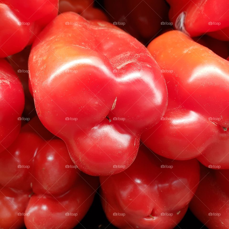 A stack of bright red bell peppers 