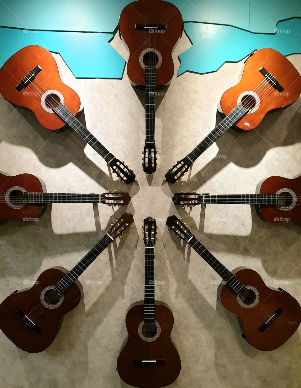 a circle of guitars on the wall
