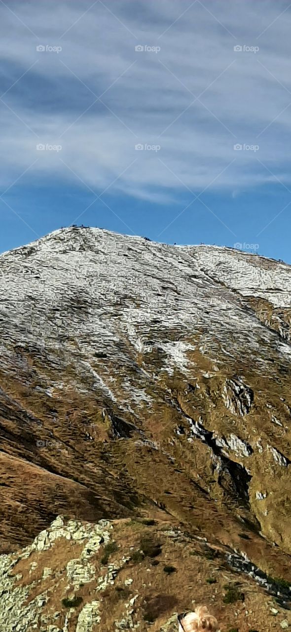 Snowy hill in autumn