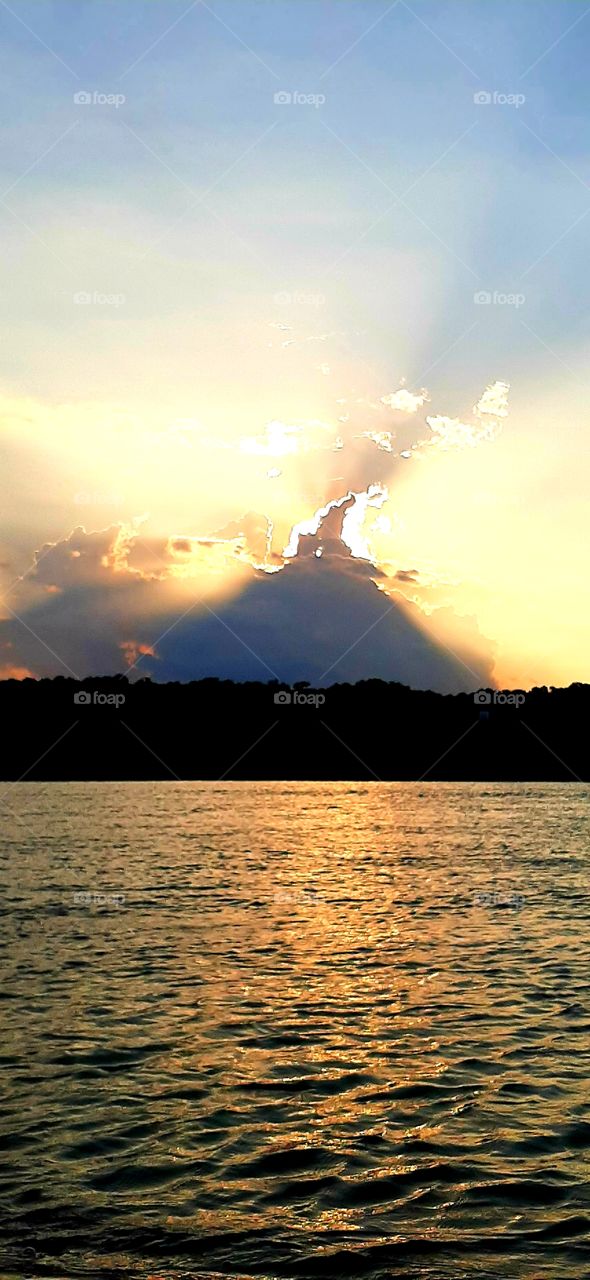 foap mission I love this waterscape sunsets over a salt marsh casting a blanket of gold over the rippled water storm cloud in background