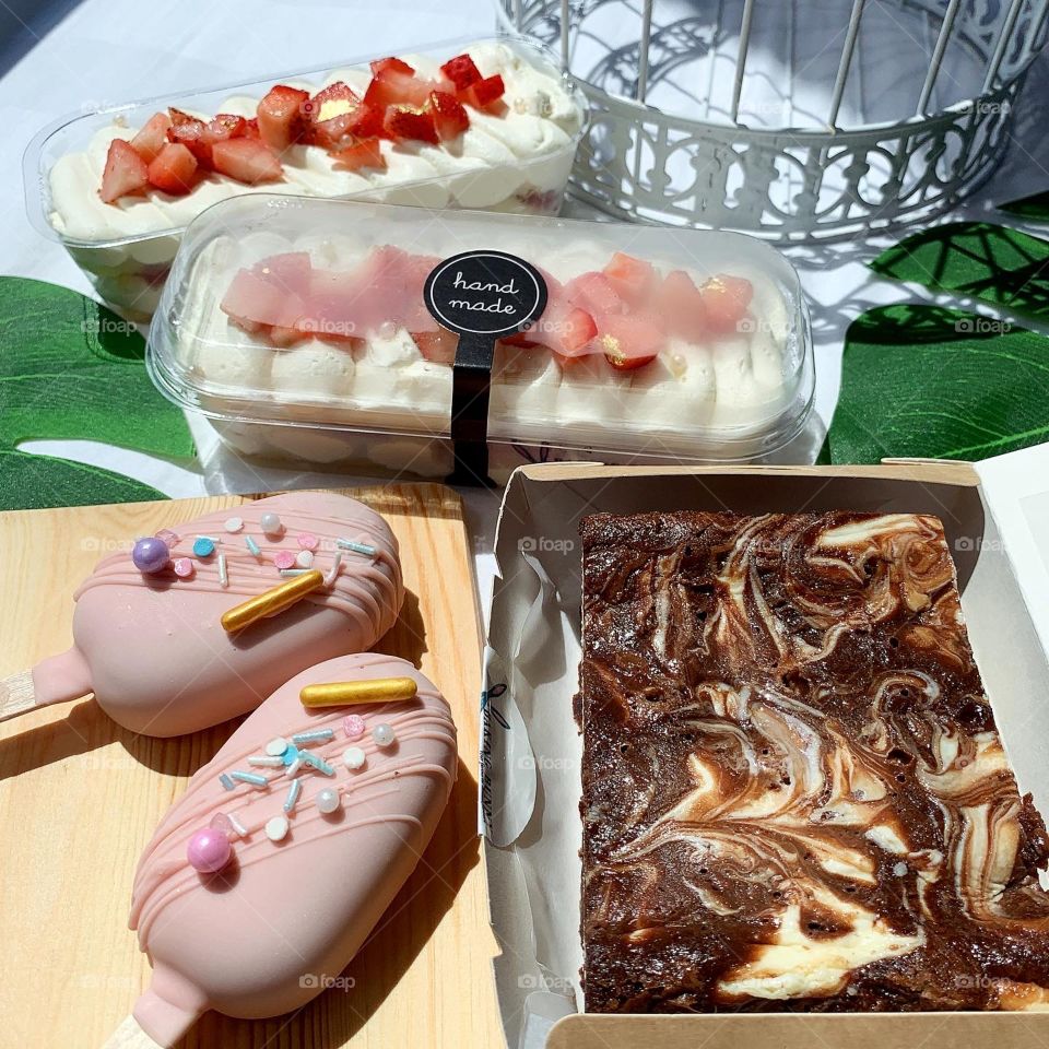 Assorted desserts in cake popsicles, strawberry shortcakes and cheesecake brownies 