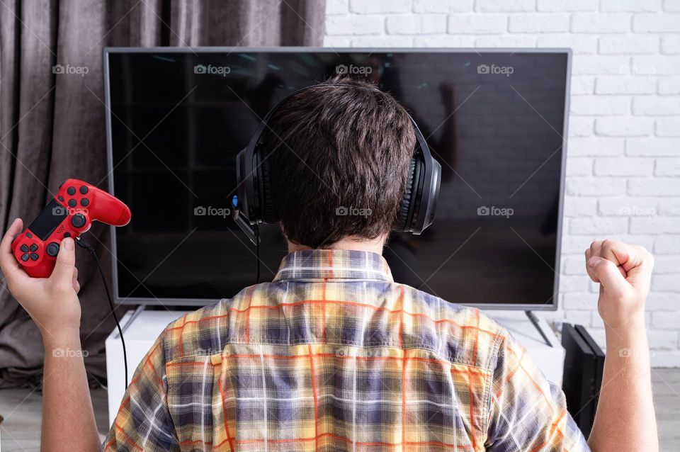 young emotional man playing video games