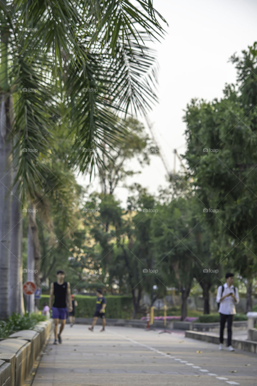 Blurry image people running exercise for health in the Benjakitti Park , Bangkok in Thailand.