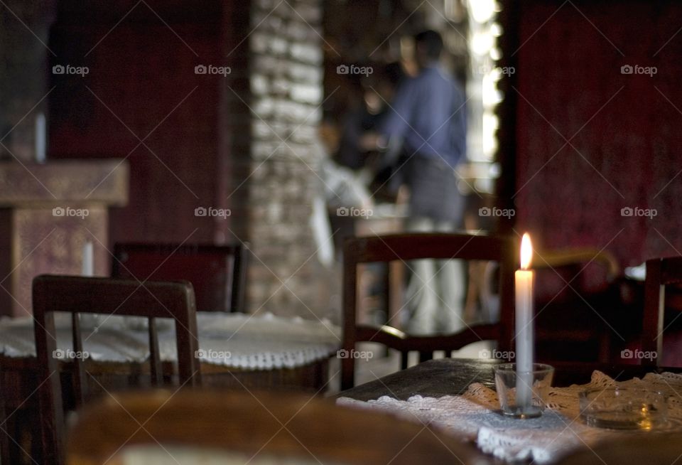 Cafe table with burning candle