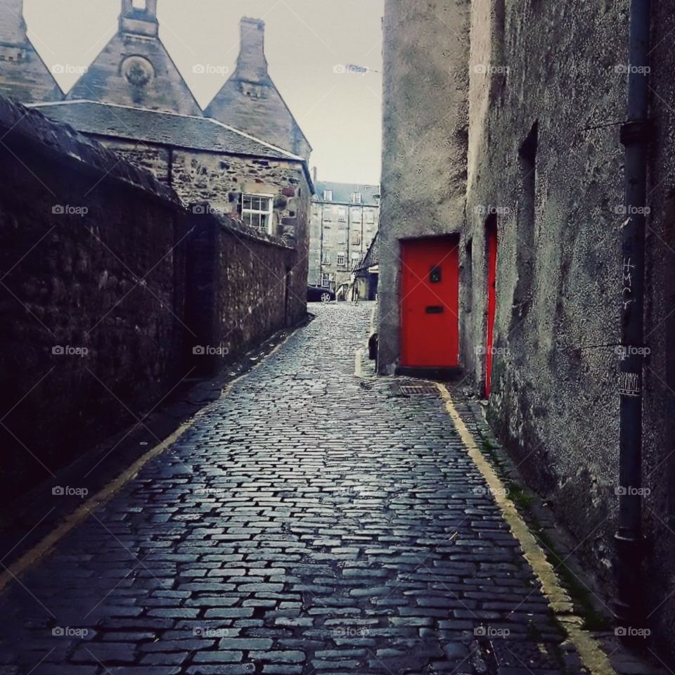 Red doorway, cobblestone alley