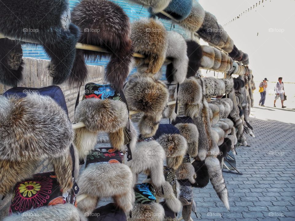 Summer hats. . Even in a hot Summer day they are trying to sell those for hats in Kiva, Uzbekistan. 