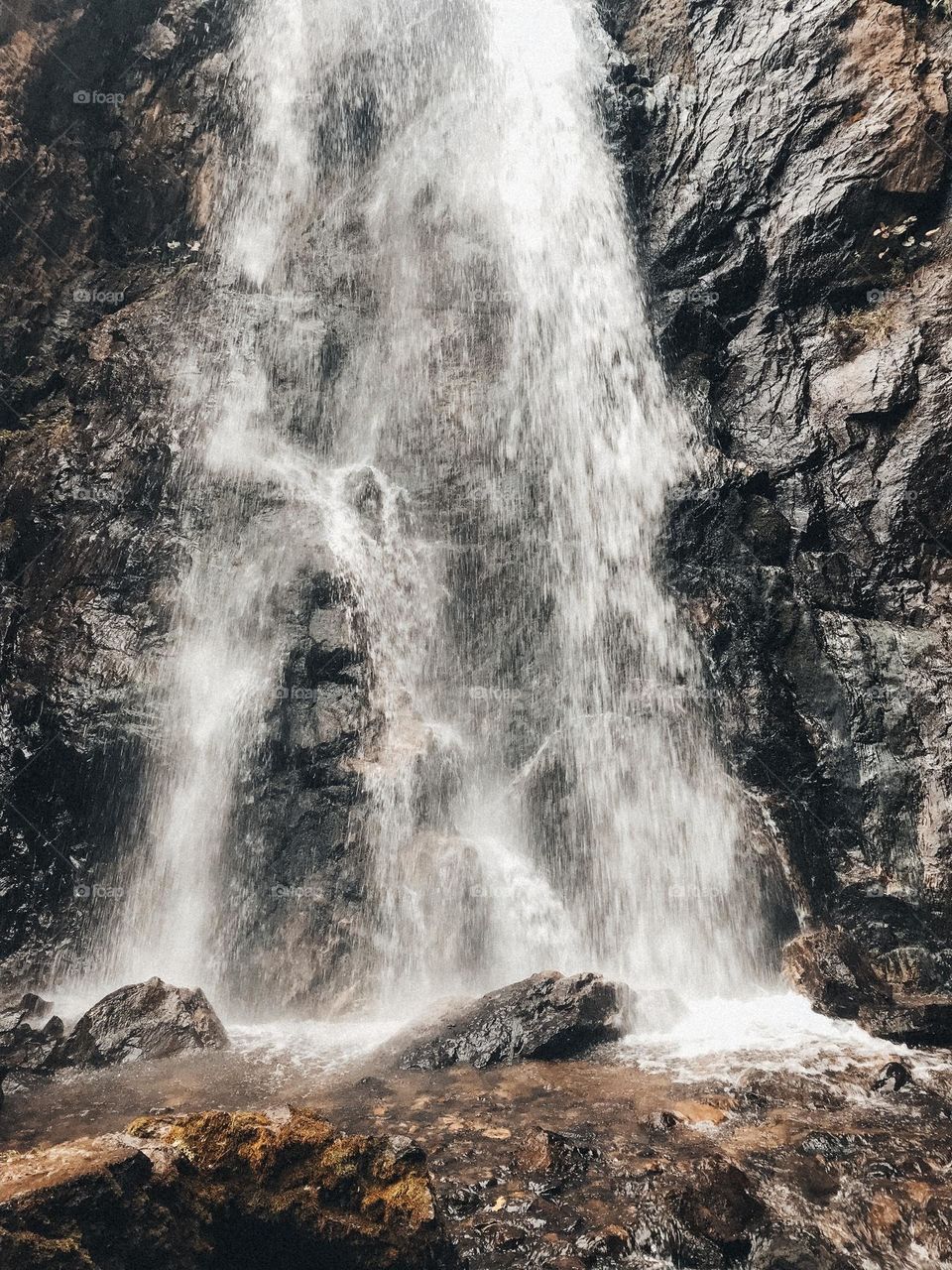 Close view on waterfall I’m Mountain river in High mountain, scenery beautiful view. Landscape nature mobile phone photo 