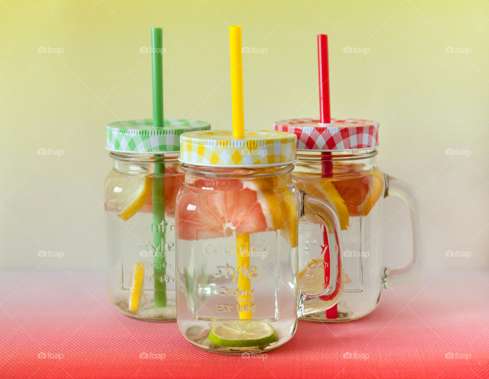 Citrus refreshing drink in colorful glass jars