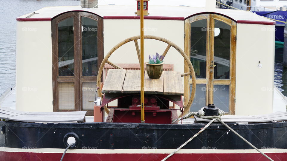 Cabin and wheel on deck of a motorboat.